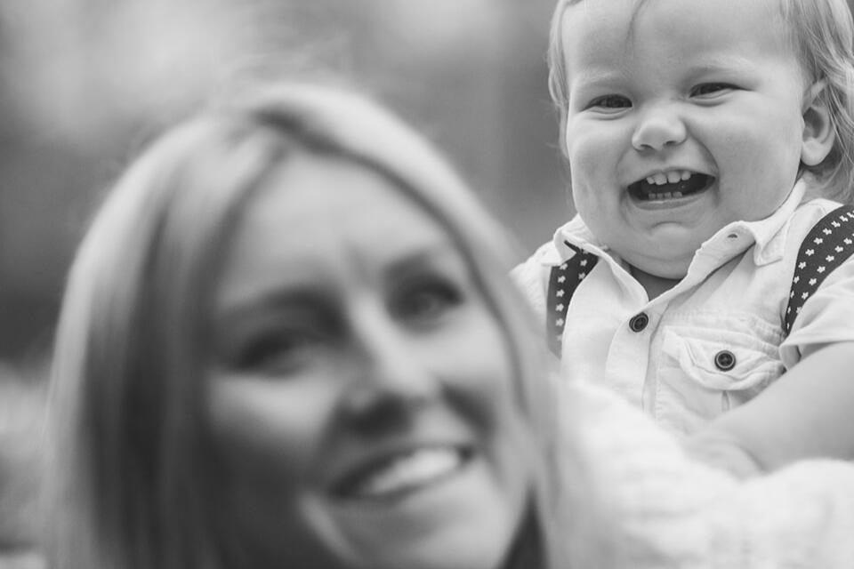 Beautiful picture of a mum playing with her baby during a at-home Christmas photo session